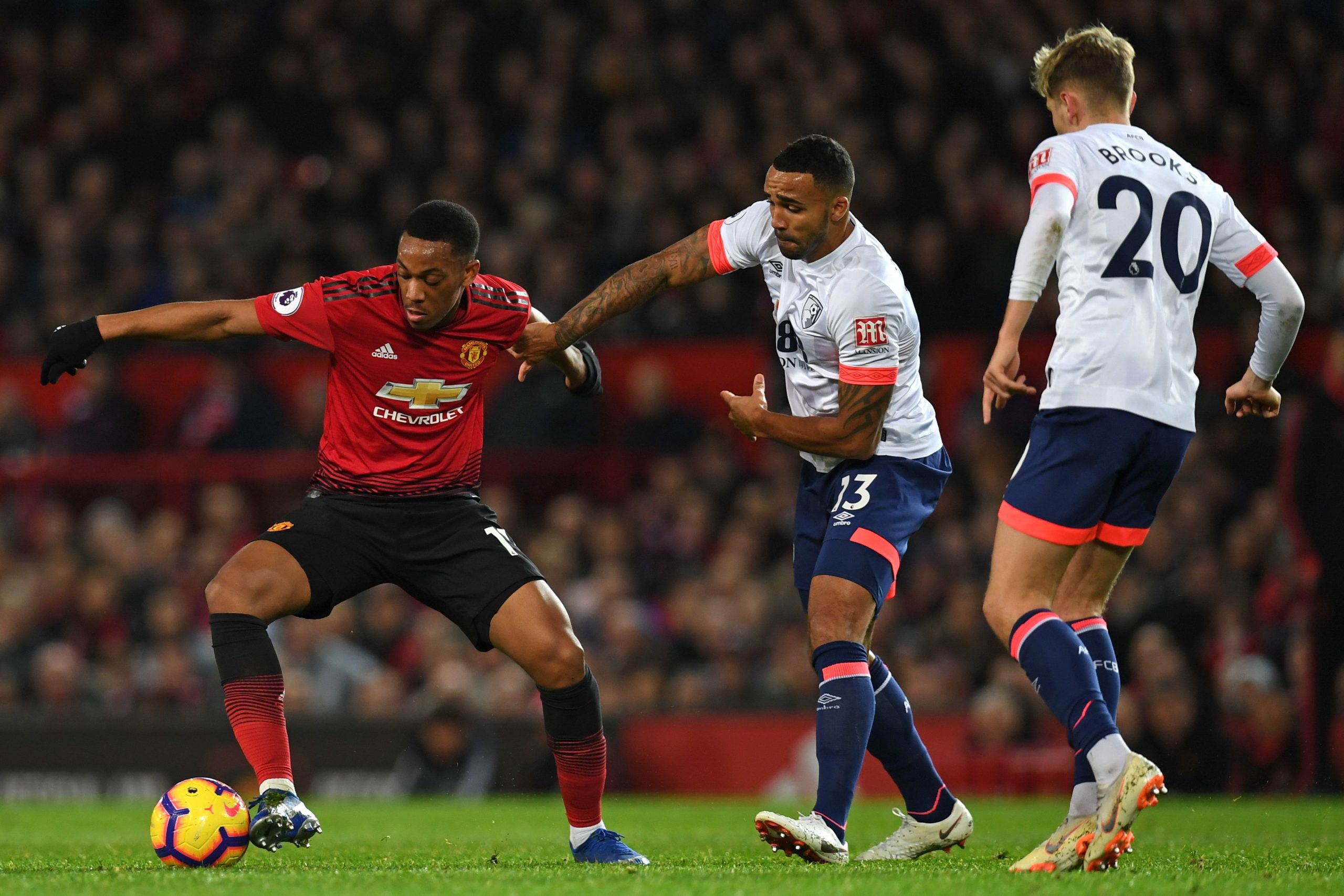 Callum Wilson and David Brooks vie for the ball against Anthony Martial