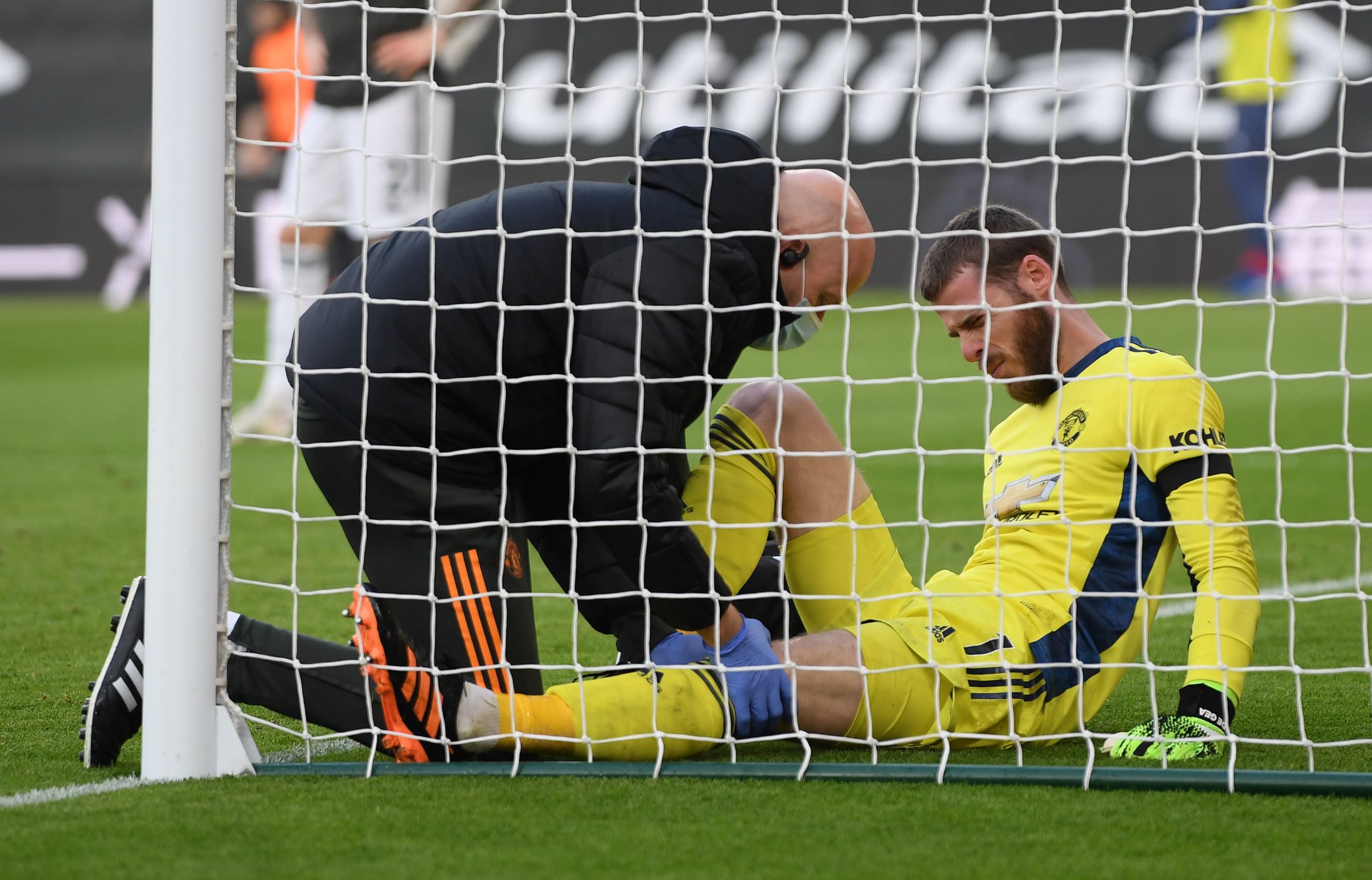 Manchester United goalkeeper David de Gea in pain after colliding with the goal-post in an attempt to save Ward-Prowse's free-kick. (GETTY Images)