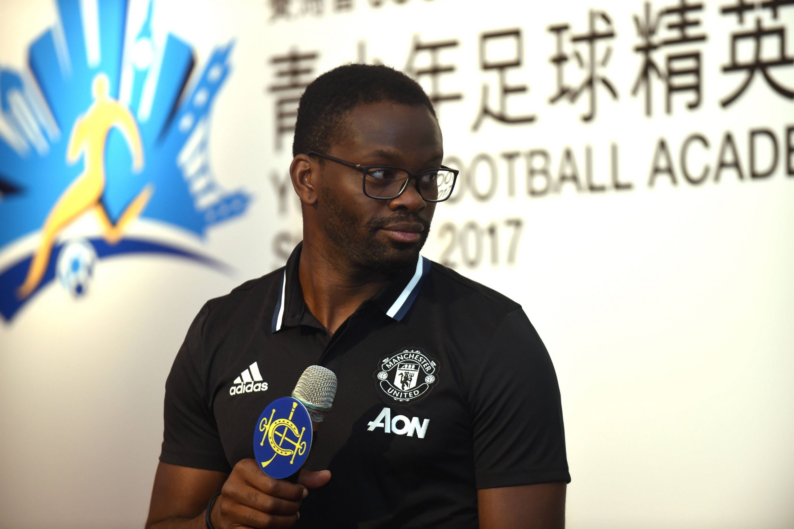 Former French soccer player Louis Saha speaks during a press conference.