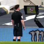Referee Chris Kavanagh consults the pitch-side monitor to check Scott McTominay's foul on Son in Spurs' defeat to Manchester United. (imago Images)