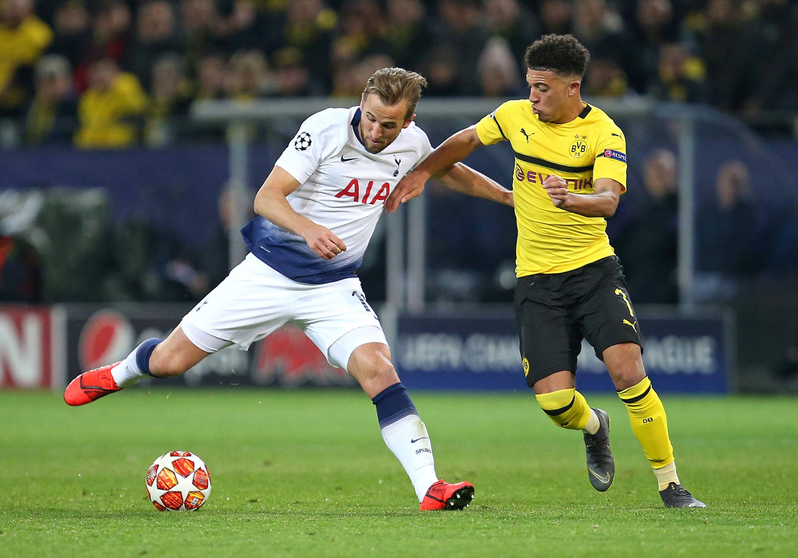 Tottenham Hotspur's Harry Kane vies for the ball with Borussia Dortmund's Jadon Sancho.