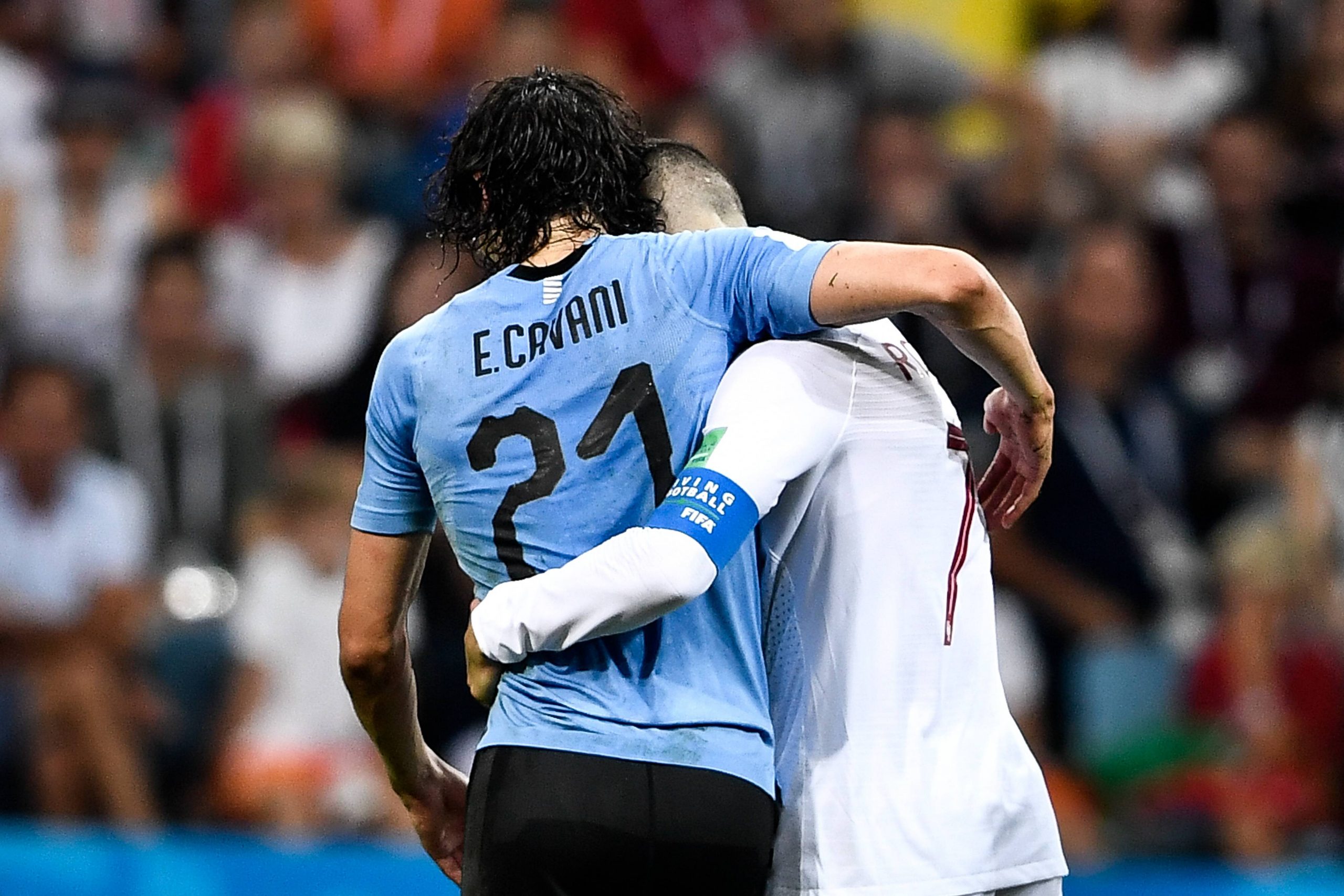 Cristiano Ronaldo of Portugal helps Edinson Cavani of Uruguay in the round of 16 match between Uruguay and Portugal during the 2018 FIFA World Cup.