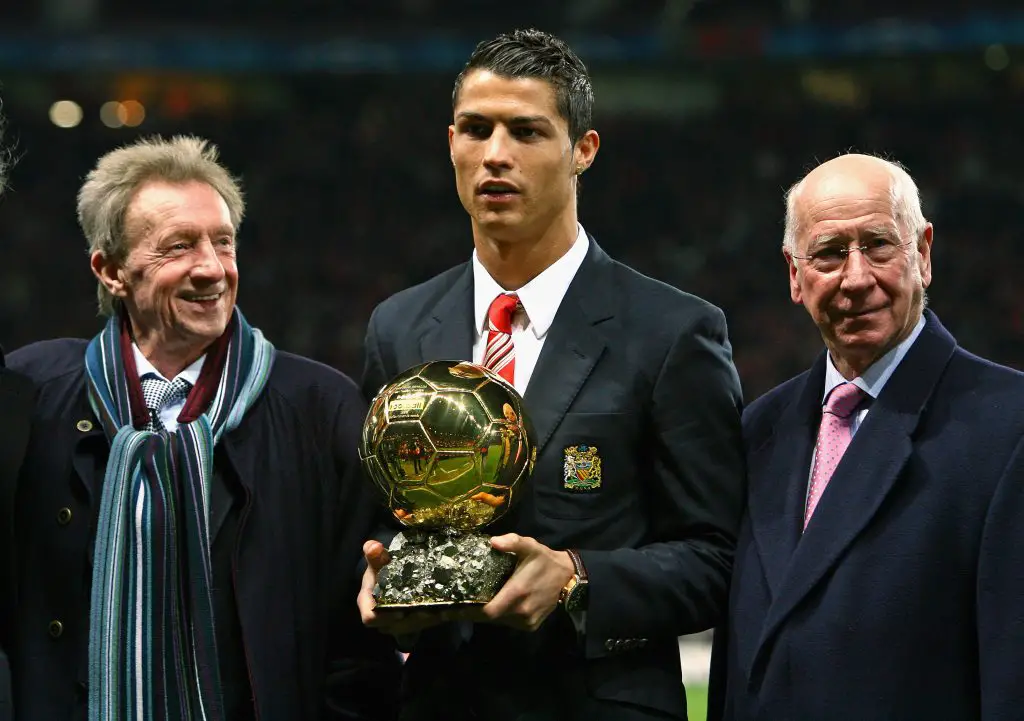 Cristiano Ronaldo (C) of Manchester United receives the Ballon d'Or by previous winners Denis Law (L) and Bobby Charlton before the UEFA Champions League Group E match between Manchester United and Aalborg at Old Trafford on December 10, 2008.  (Photo by Alex Livesey/Getty Images)