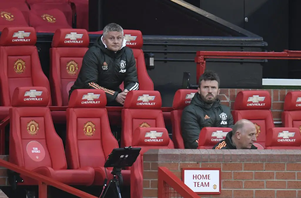 Ole Gunnar Solskjaer, Manager of Manchester United and Michael Carrick, First Team Coach look on during the Premier League match between Manchester United and Liverpool at Old Trafford on May 13, 2021 in Manchester, England. Sporting stadiums around the UK remain under strict restrictions due to the Coronavirus Pandemic as Government social distancing laws prohibit fans inside venues resulting in games being played behind closed doors.