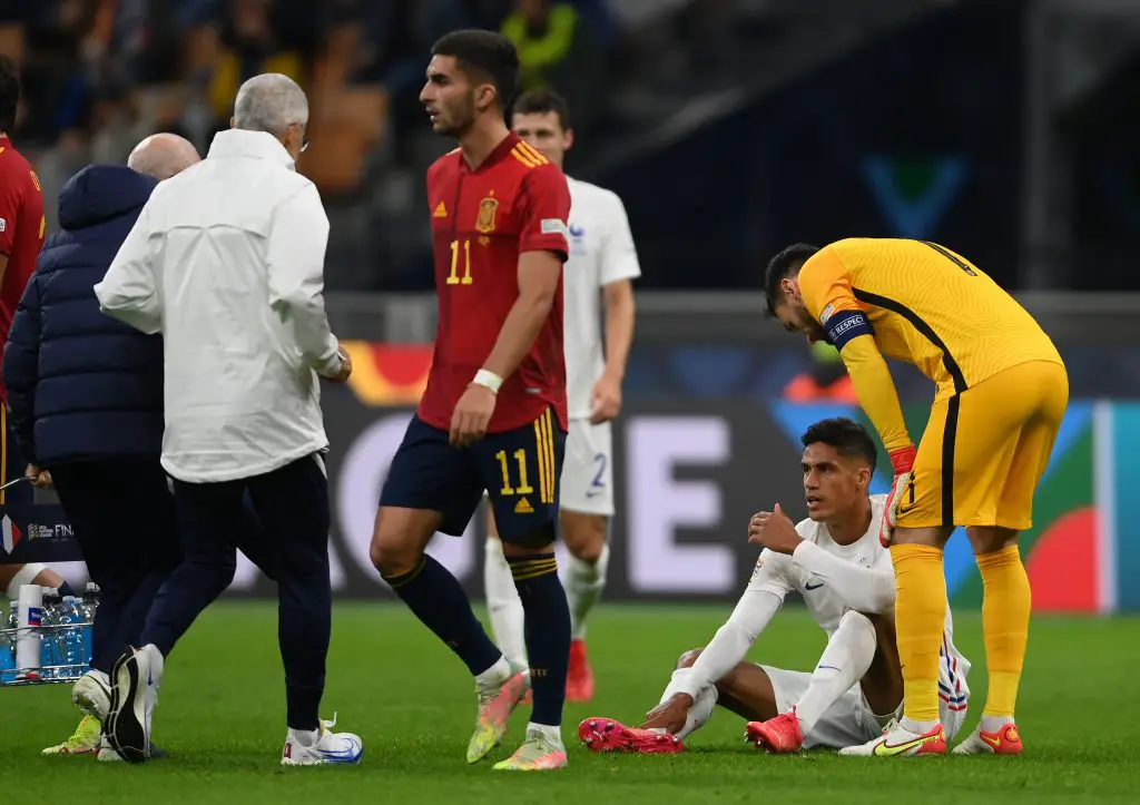 Raphael Varane of France lies on the floor as they receive medical attention during the UEFA Nations League 2021 Final match between Spain and France at San Siro Stadium.