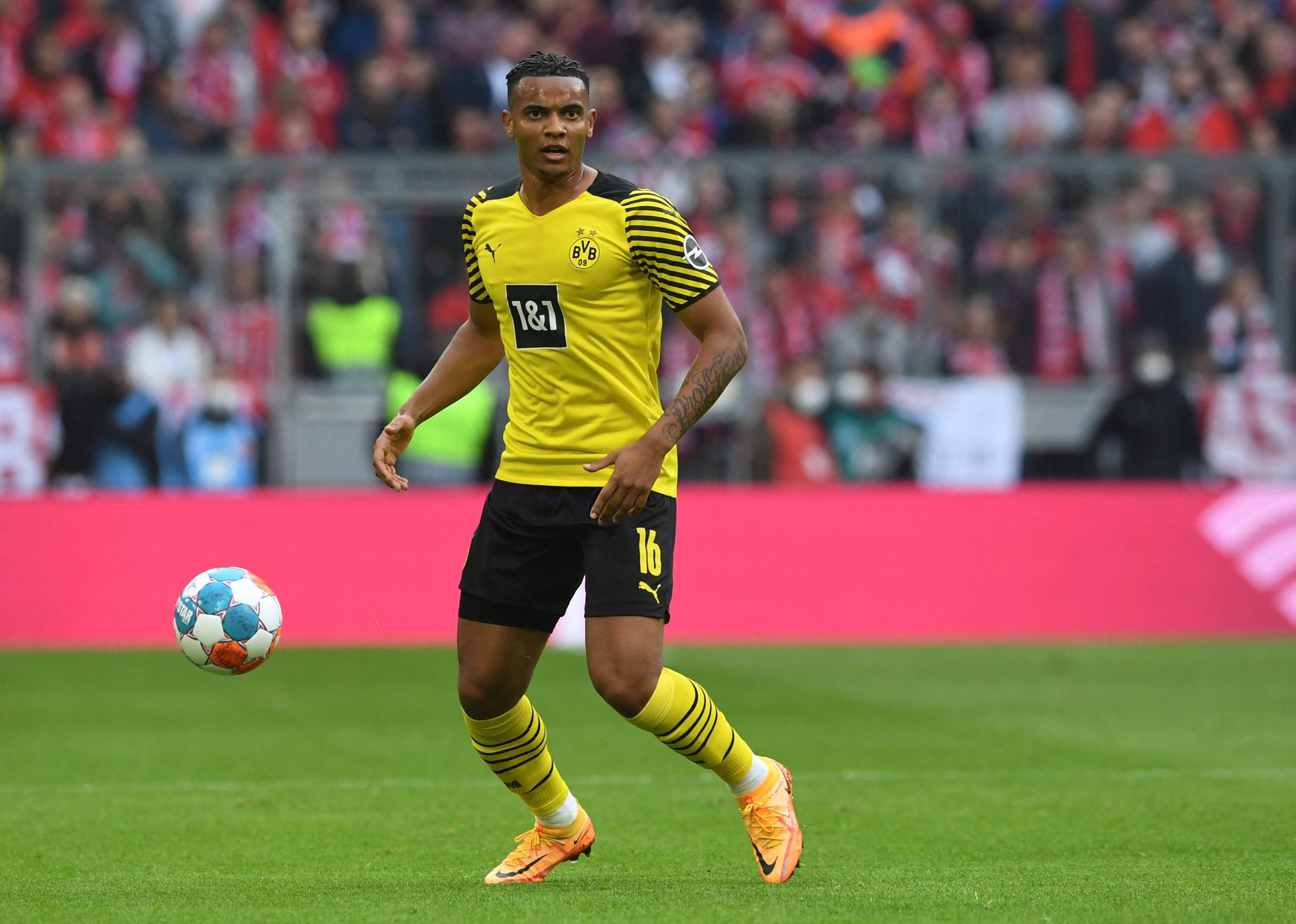 Manuel Akanji plays the ball during the German first division Bundesliga match between FC Bayern Munich and Borussia Dortmund. (Photo by Christof STACHE / AFP) / DFL REGULATIONS PROHIBIT ANY USE OF PHOTOGRAPHS AS IMAGE SEQUENCES AND/OR QUASI-VIDEO (Photo by CHRISTOF STACHE/AFP via Getty Images)