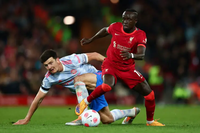 Harry Maguire of Manchester United looks on as Sadio Mane of Liverpool runs with the ball. (Photo by Clive Brunskill/Getty Images)
