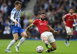 Brighton's Solly March (L) vies with Manchester United's Bruno Fernandes.