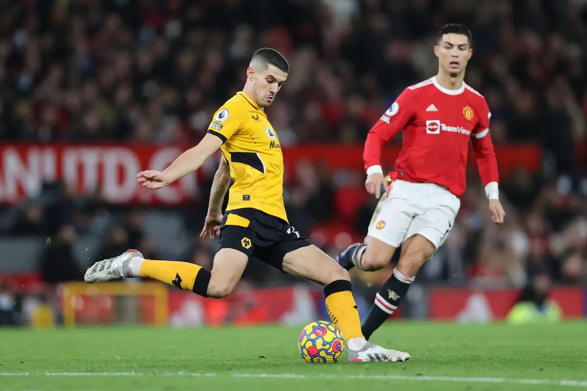 Conor Coady of Wolverhampton Wanderers clears the ball as Cristiano Ronaldo watches on.