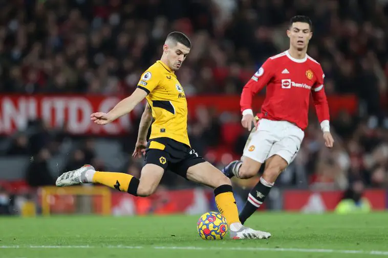 Conor Coady of Wolverhampton Wanderers clears the ball as Cristiano Ronaldo watches on.