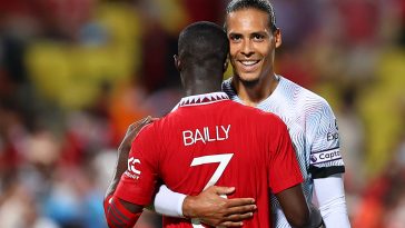 Eric Bailly of Manchester United embraces Virgil van Dijk of Liverpool.