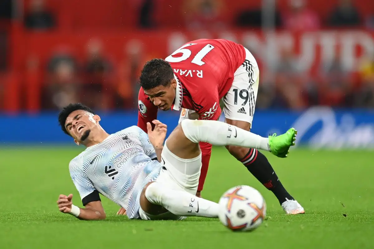 Luis Diaz of Liverpool is challenged by Raphael Varane of Manchester United.