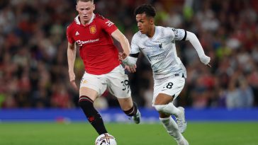 Fabio Carvalho of Liverpool runs with the ball whilst under pressure from Scott McTominay of Manchester United.