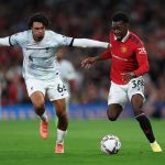 Anthony Elanga of Manchester United is challenged by Trent Alexander-Arnold of Liverpool.