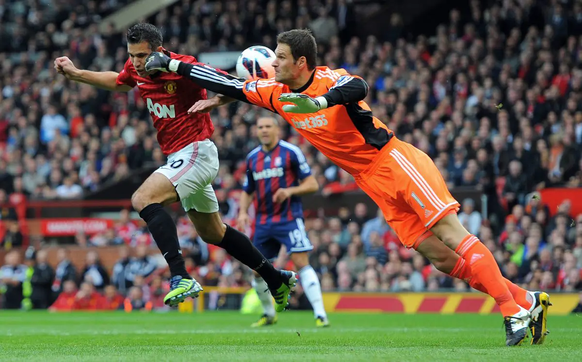 Asmir Begovic collides with Manchester United's Robin van Persie. 