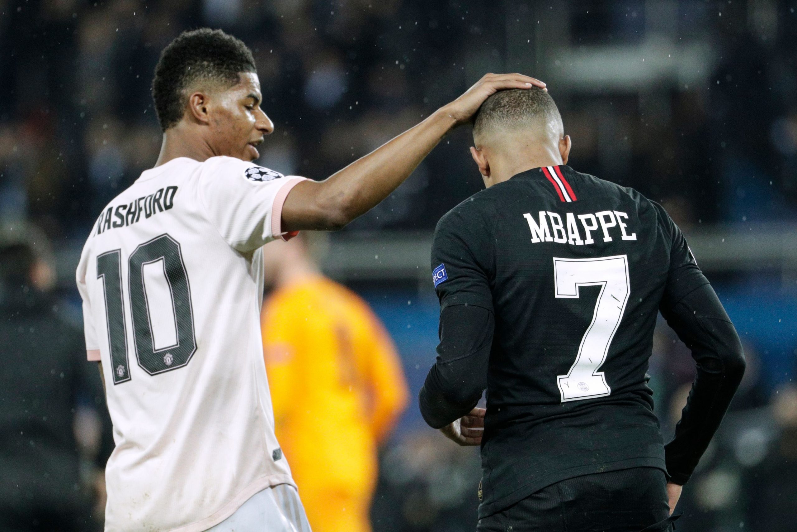 Marcus Rashford of Manchester United with Paris Saint-Germain's Kylian Mbappe during a UEFA Champions League match.
