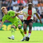 Scott McTominay of Manchester United is challenged by Joe Aribo of Southampton.