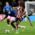 Cody Gakpo of PSV Eindhoven challenges Glen Kamara of Glasgow Rangers during a UEFA Champions League game.
