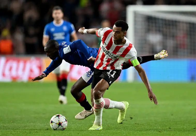 Cody Gakpo of PSV Eindhoven challenges Glen Kamara of Glasgow Rangers during a UEFA Champions League game.