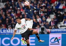 Raphael Varane (R) heads the ball from Austria's Karim Onisiw during a UEFA Nations League game.