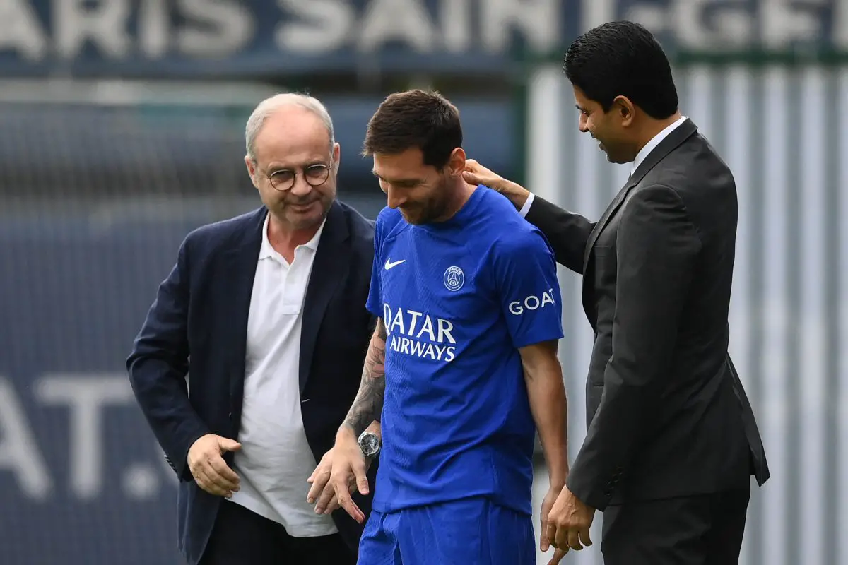 Luis Campos and Nasser Al-Khelaifi (R) greet Paris Saint-Germain's Lionel Messi as he arrives for a training session. 