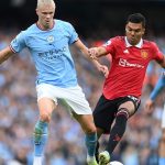 Erling Haaland of Manchester City put under pressure by Manchester United's Casemiro.