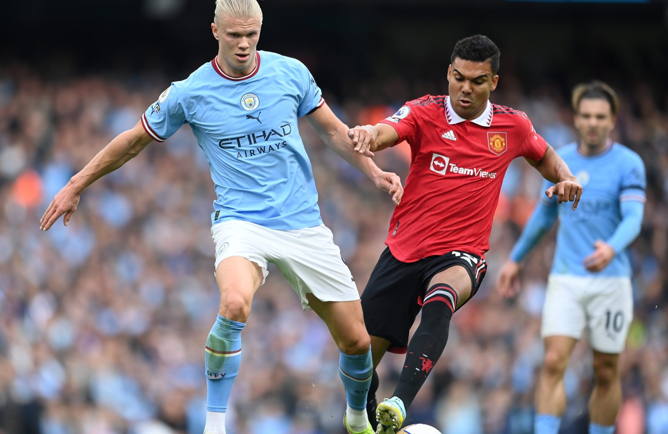Erling Haaland of Manchester City put under pressure by Manchester United's Casemiro.