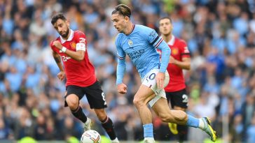 Jack Grealish of Manchester City in action with Bruno Fernandes of Manchester United.