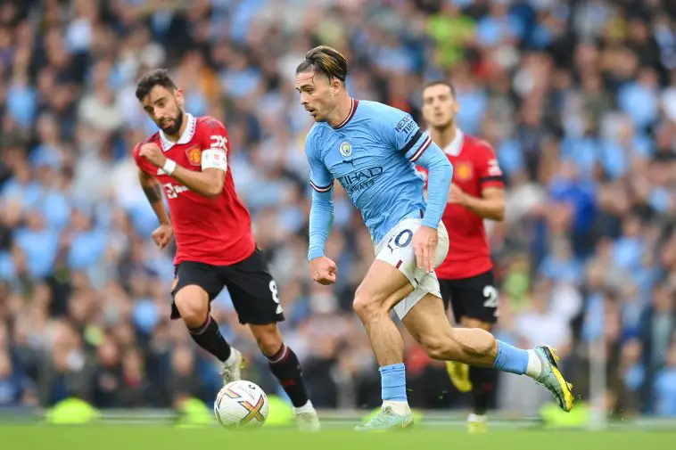 Jack Grealish of Manchester City in action with Bruno Fernandes of Manchester United.