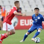 Russia's Ilya Samoshnikov and Cyprus' Loizos Loizou vie for the ball during a 2022 Qatar World Cup European Qualifiers match.