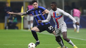 Ousmane Dembele of FC Barcelona is challenged by Alessandro Bastoni of Inter Milan in a UEFA Champions League game.