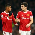 Raphael Varane talks to Harry Maguire of Manchester United during a game against Tottenham Hotspur.