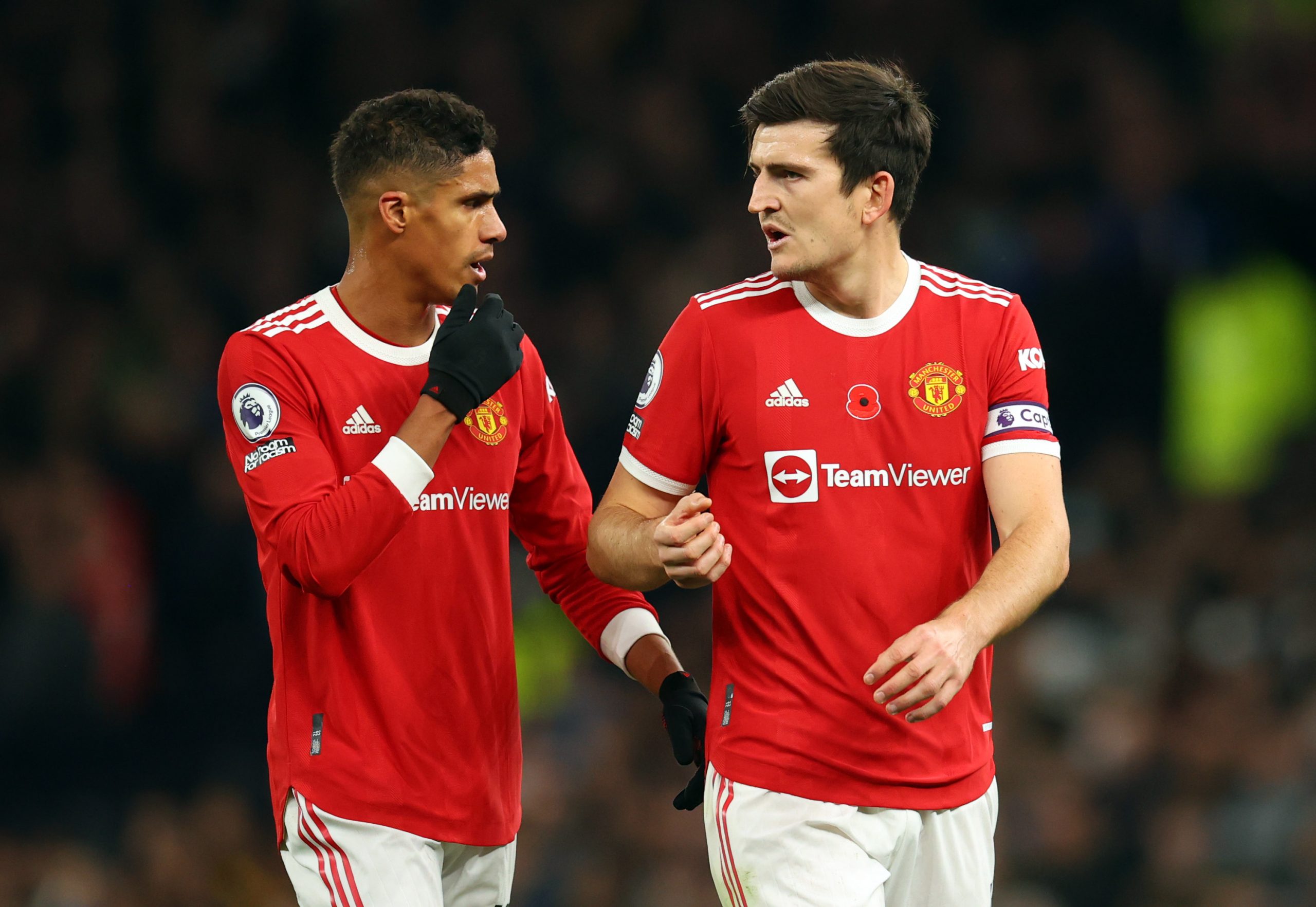 Raphael Varane talks to Harry Maguire of Manchester United during a game against Tottenham Hotspur.