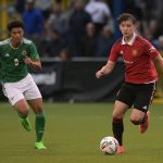 Louis Jackson of Manchester United and Reece Evans of Northern Ireland during the NI Super Cup match.
