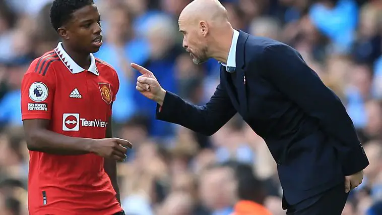 Manchester United's Erik ten Hag speaks to left-back Tyrell Malacia during the Manchester derby.