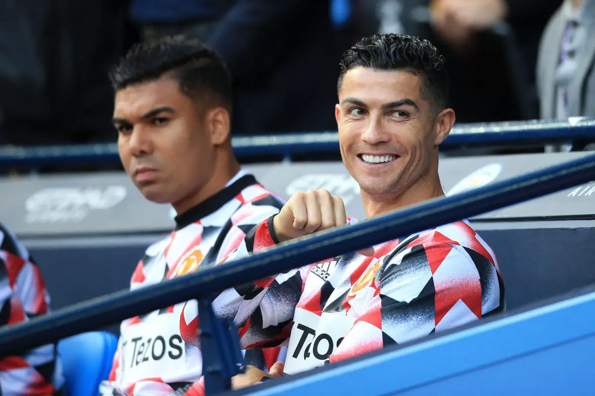 Cristiano Ronaldo sits on the bench with Casemiro of Manchester United against Man City. 