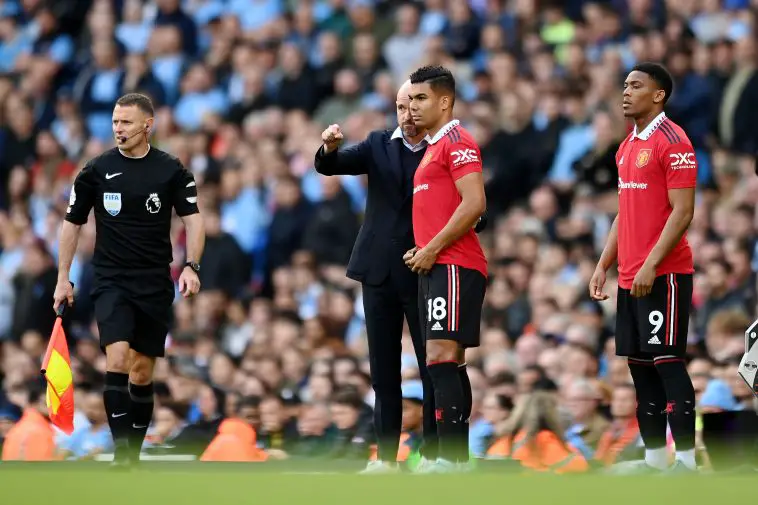 Erik ten Hag, Manager of Manchester United interacts with Casemiro of Manchester United during the Premier League match between Manchester City and Manchester United at Etihad Stadium on October 02, 2022 in Manchester, England.