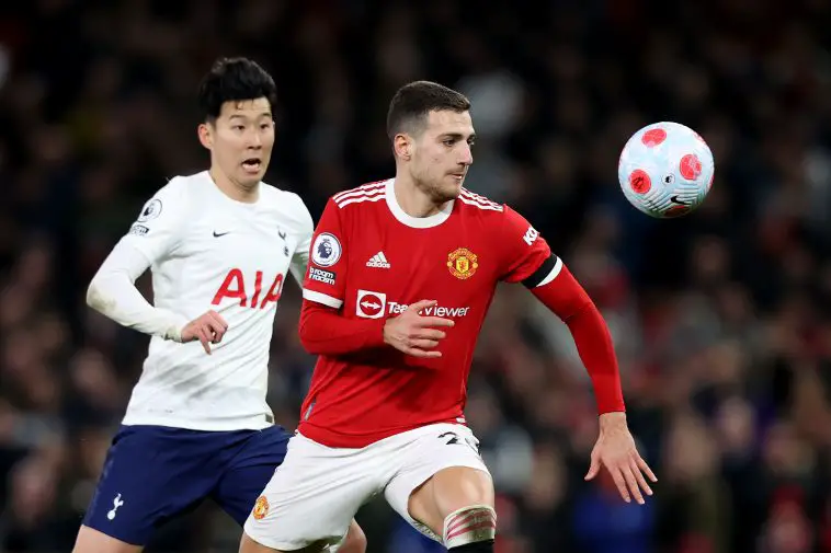 Heung-Min Son of Tottenham Hotspur looks on as Diogo Dalot of Manchester United controls the ball during the Premier League match between Manchester United and Tottenham Hotspur at Old Trafford on March 12, 2022 in Manchester, England.