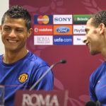 Manchester United star Rio Ferdinand (R) and Cristiano Ronaldo share a joke during a press conference in May 2009. (Image by LLUIS GENE/AFP via Getty Images)