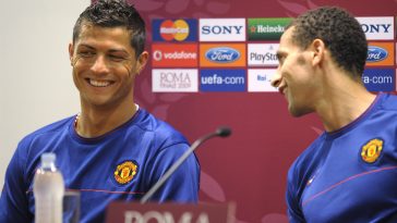 Manchester United star Rio Ferdinand (R) and Cristiano Ronaldo share a joke during a press conference in May 2009. (Image by LLUIS GENE/AFP via Getty Images)