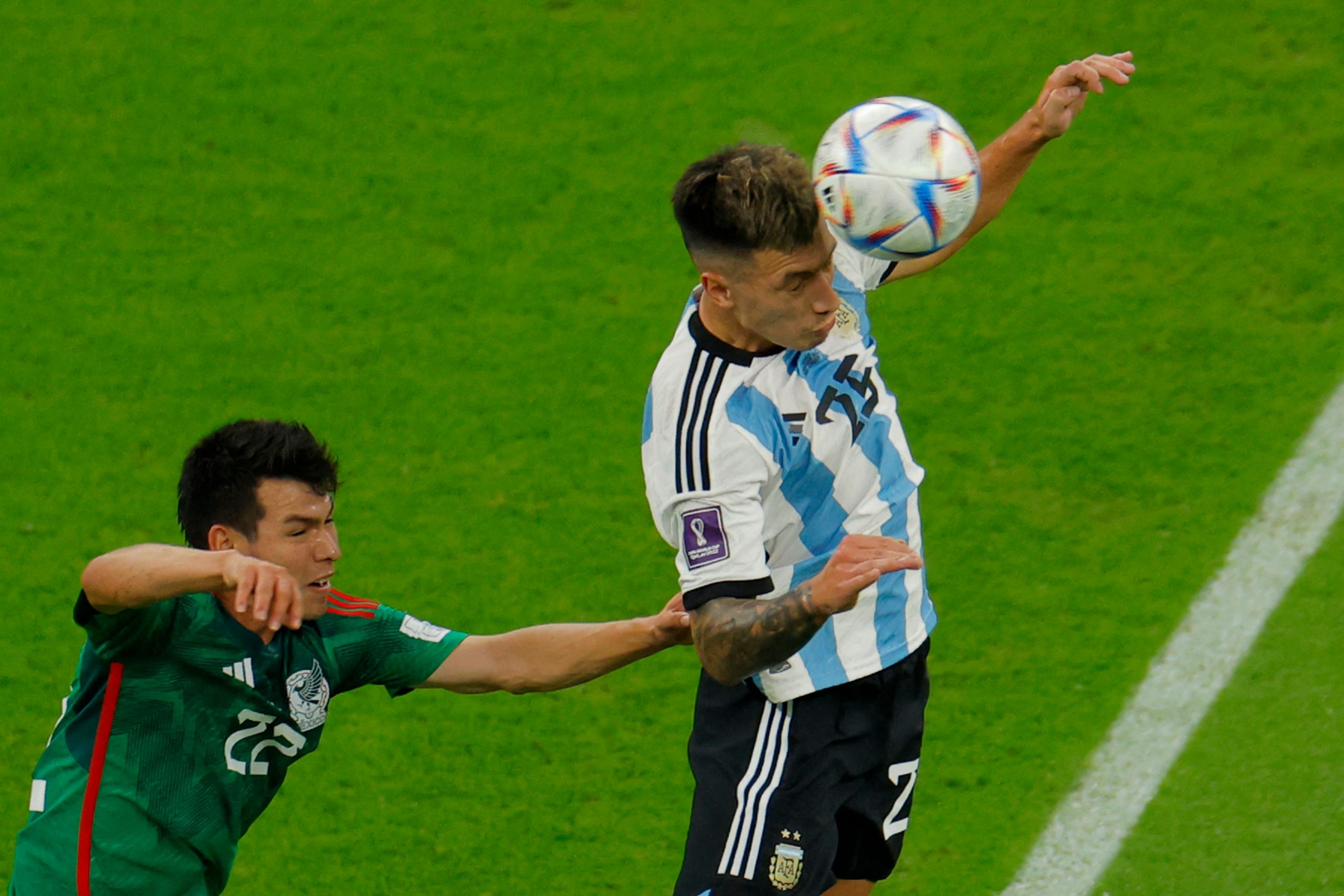 Mexico's Hirving Lozano fights for the ball with Argentina's Lisandro Martinez. (Photo by ODD ANDERSEN/AFP via Getty Images)