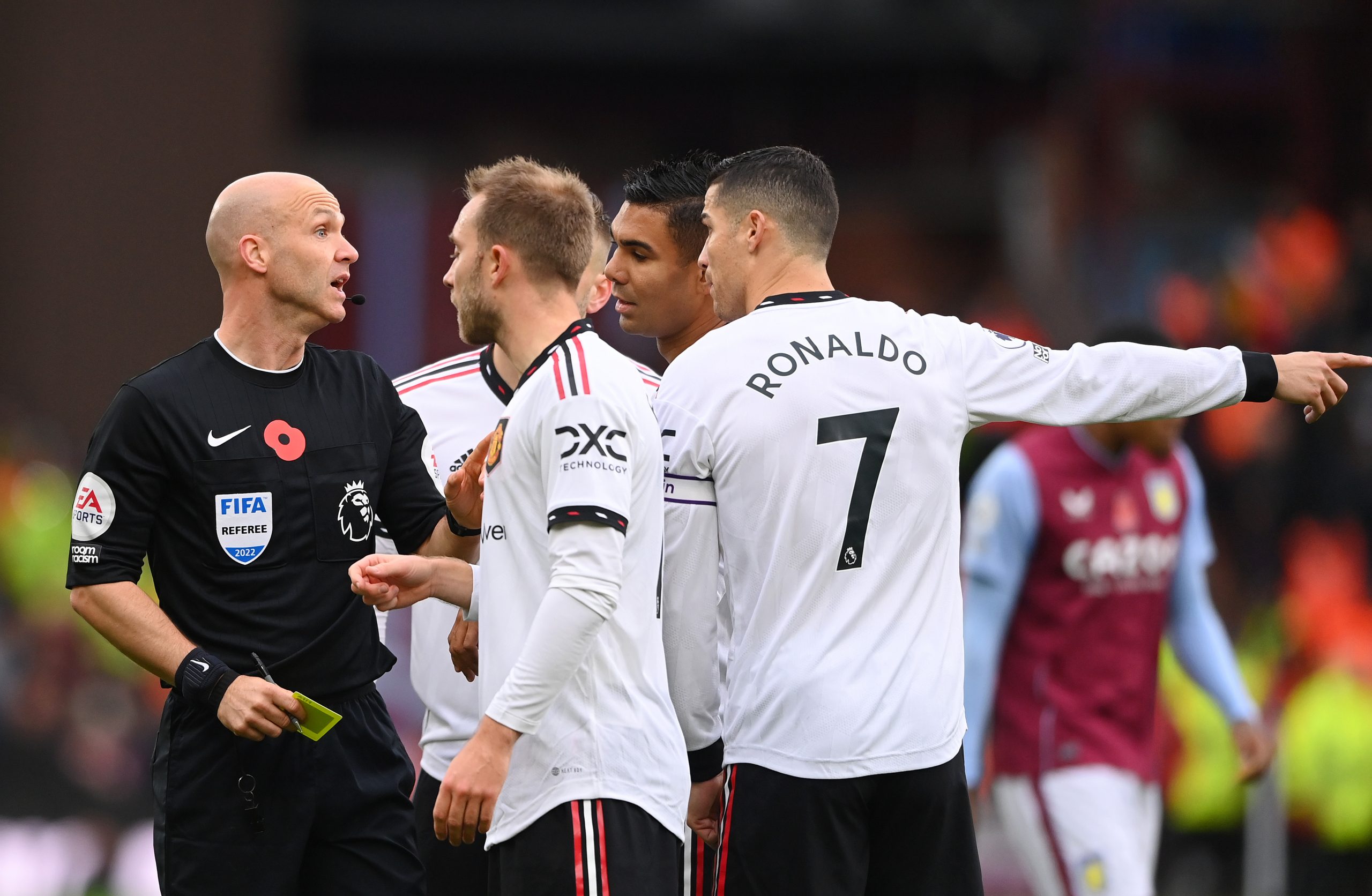 Referee Anthony Taylor is confronted by Christian Eriksen and Cristiano Ronaldo of Manchester United during the Premier League match between Aston Villa and Manchester United at Villa Park on November 06, 2022 in Birmingham, England