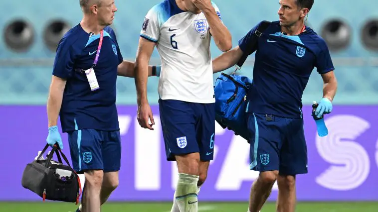 Harry Maguire of England walks off the pitch with medical staffs after being substituted as he picks up an injury during the FIFA World Cup Qatar 2022 Group B match between England and IR Iran at Khalifa International Stadium on November 21, 2022 in Doha, Qatar.