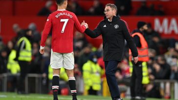 Manchester United's Portuguese striker Cristiano Ronaldo (L) and Manchester United German Interim head coach Ralf Rangnick (R) shake hands after the final whistle of the English Premier League football match between Manchester United and Crystal Palace at Old Trafford in Manchester, north west England, on December 5, 2021.