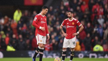 Manchester United's Portuguese striker Cristiano Ronaldo (L) and Manchester United's Portuguese midfielder Bruno Fernandes reacts during the English Premier League football match between Manchester United and Manchester City at Old Trafford in Manchester, north west England, on November 6, 2021.
