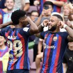 Barcelona's Dutch forward Memphis Depay (R) celebrates scoring his team's second goal during the Spanish League football match between FC Barcelona and Elche CF at the Camp Nou stadium in Barcelona on September 17, 2022.