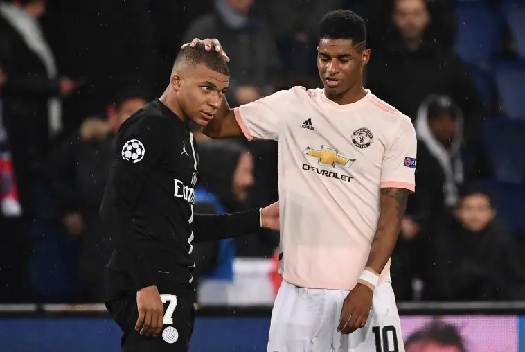 Manchester United's English forward Marcus Rashford (R) cheers up Paris Saint-Germain's French forward Kylian Mbappe at the end of the UEFA Champions League round of 16 second-leg football match between Paris Saint-Germain (PSG) and Manchester United at the Parc des Princes stadium in Paris on March 6, 2019.