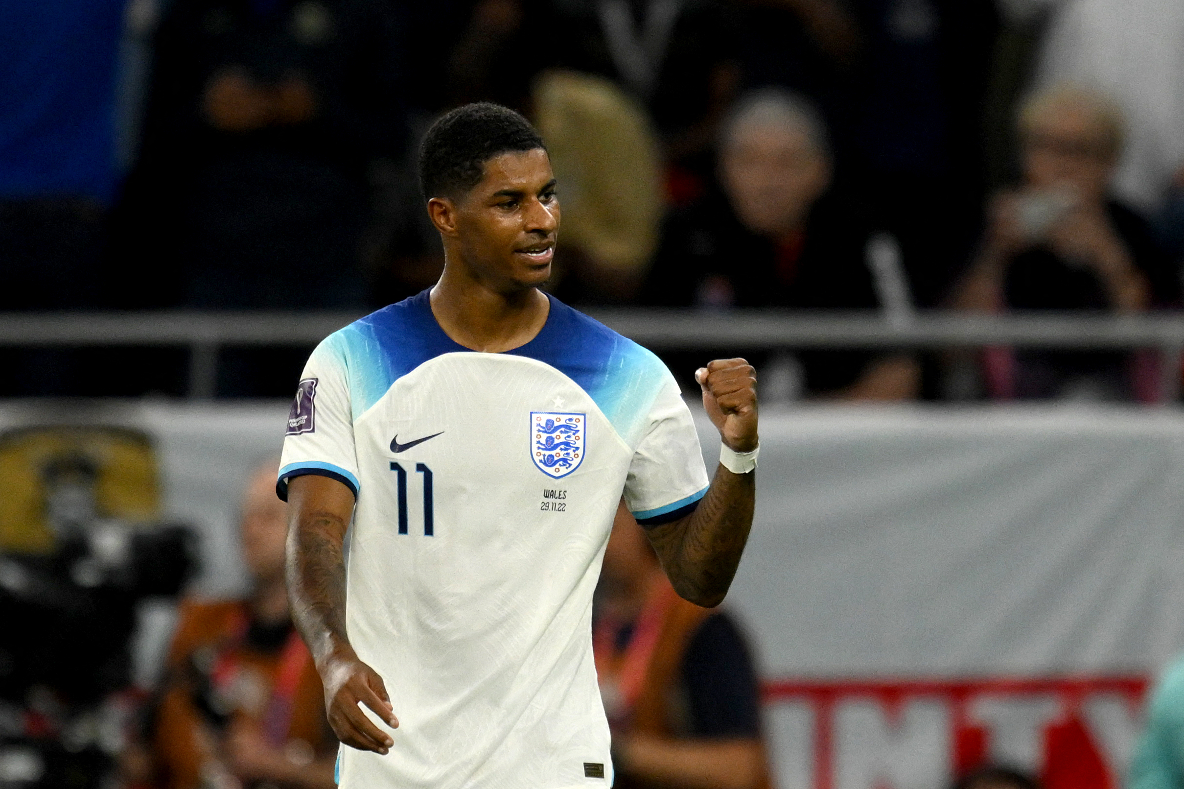 England's forward #11 Marcus Rashford celebrates after scoring his team's third goal during the Qatar 2022 World Cup Group B football match between Wales and England at the Ahmad Bin Ali Stadium in Al-Rayyan, west of Doha on November 29, 2022.