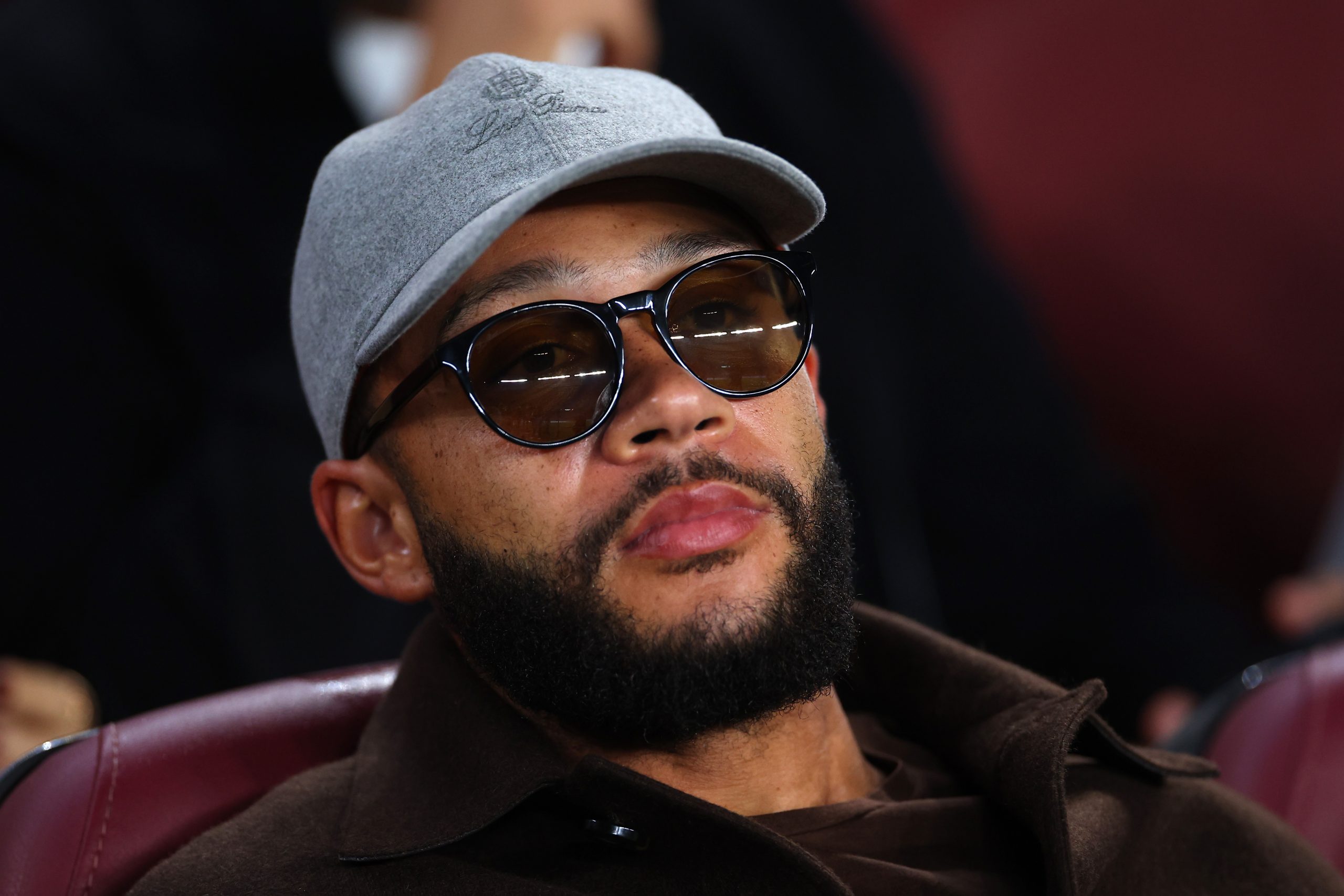 Memphis Depay of FC Barcelona looks on from the stands during the UEFA Champions League group C match between FC Barcelona and FC Bayern München at Spotify Camp Nou on October 26, 2022 in Barcelona, Spain