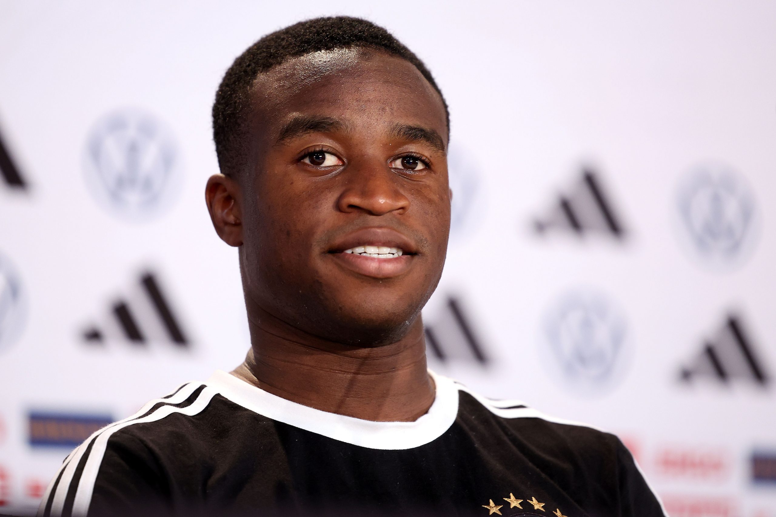 Youssofa Moukoko of Germany talks to the media during the Germany press conference at DFB Media Centre on November 19, 2022 in Al Ruwais, Qatar.